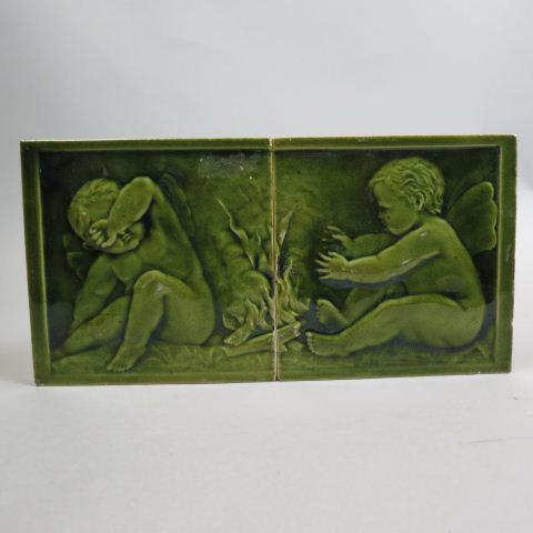 Pair of U.S. Encaustic Tile Majolica Plaques,: cherubs by the fire, green, each 6".