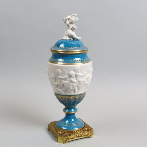 French Porcelain & Bronze Ormolu Covered Jar,: raised putti & cherubs, blue & gold trim, cherub finial , ormolu base, 13 1/2" tall, a beauty!