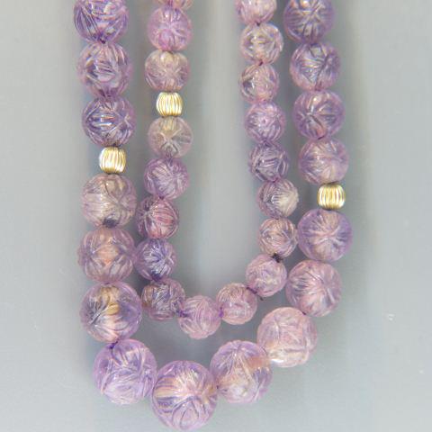 Carved Amethyst & 14K Gold Bead Necklace,: 85 graduated beads, 8 to 12.5 mm, with yellow gold spacers, 30" long.