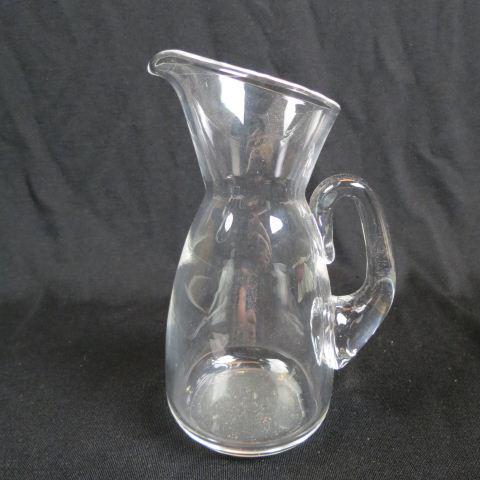 Steuben Crystal Pitcher,: 8 1/2", signed, excellent.....Steuben Glass is one of America’s most cherished producers of collectible crystal. Whether it is a Steuben vase, bowl, figurine, or sculpture, Steuben pieces are always