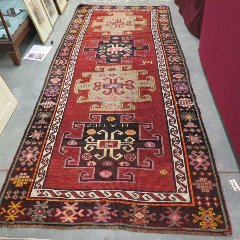 Kazak Turkish Handmade Rug,: four large geometric designs, dark salmon field, indigo star & stylized floral borders, 4'4" x 9'10".