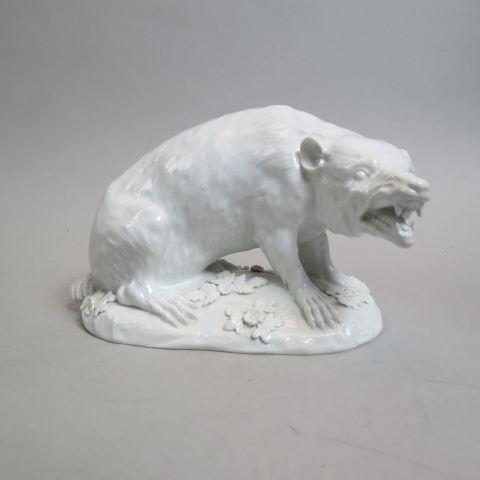 Meissen Porcelain Figurine of a Wolverine,: white or blanc de chene style glaze, applied flowers and leaves, crossed swords mark, 5" tall, 7 1/2" long, excellent.