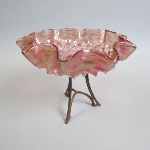 Loetz Type Art Glass Compote,: iridescent mottled cranberry floraform glass on bronzed tripod stand, 9" diameter, 7 1/4" tall, excellent.