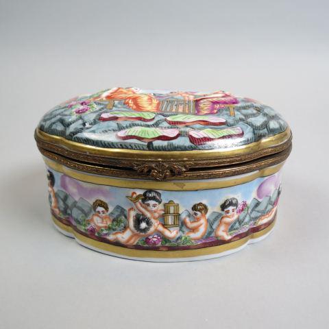Capodimonte Porcelain Oval Dresser Box,: maidens releasing cupids from a cage, bronze ormolu mounts, 5 1/2" X 7 1/2", excellent.