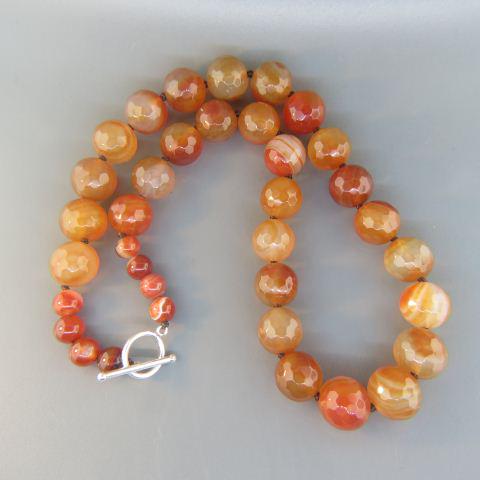 Carnelian Necklace,: 28 faceted 14 mm beads and 8 round 8 mm beads, sterling silver clasp, 20" long.