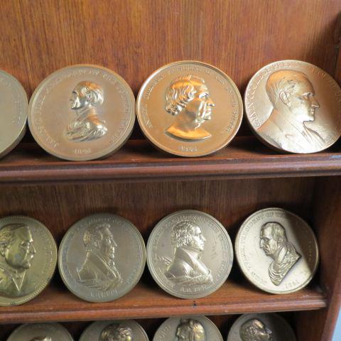 24 U.S. Mint Bronze Presidential Medals,: 3" diameter, includes Inaugural, Peace & Treaty type, mixed, with wooden display shelf.