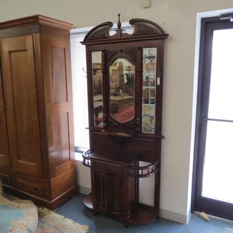 Mahogany Hall Tree with Beveled Mirrors,: broken arch style top, drawer with lower doors, side umbrella holders, hat racks, 88" tall, 39" wide.