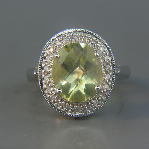 Lemon Quartz & Diamond Ring,: fancy cut oval gem weighing 5 carats surrounded by round diamonds in 14K white gold, 7.8 grams, currently size 7 1/4.