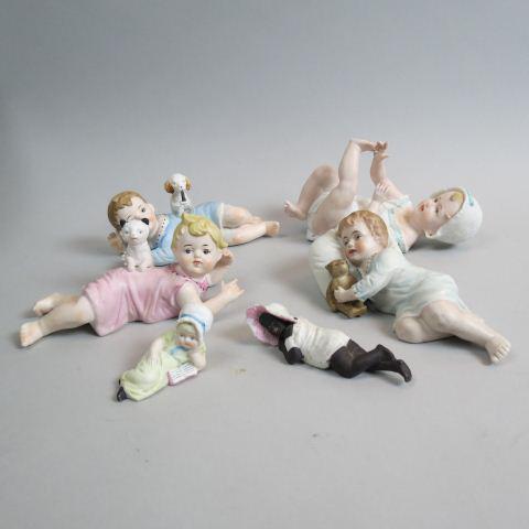 6 Antique Bisque "Piano Baby" Figurines,: children in various poses, most German made, one with teddy bear, one with cat, one with dog, one reading, one black child (chip on hat), 3" to 7" long