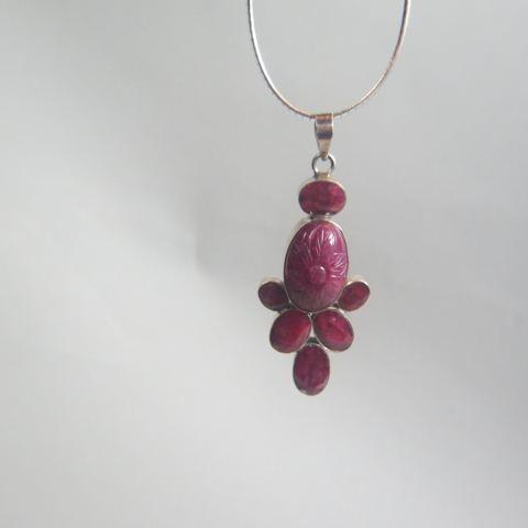 Ruby Pendant,: seven African oval gems, largest is carved cabochon shape of 18 x 27 mm, totaling approx 90 carats in sterling silver, 3" long on 18" long sterling chain, 48 grams.