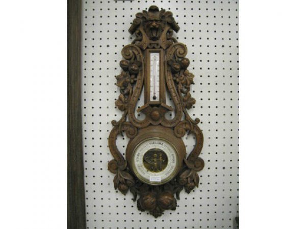 Black Forest Victorian Carved Wooden Barometer, wi: with thermometer, lion head at top, fruit trim, 12" x 27".