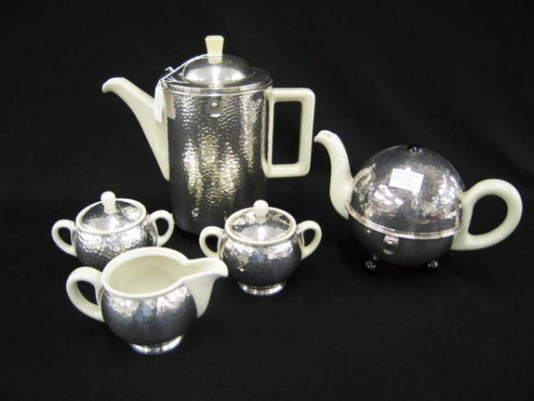 German Art Deco Silver & Pottery Tea & Coffee Set: including creamer and two sugars sterling clad and teapot & coffeepot in silverplate insulated holders.