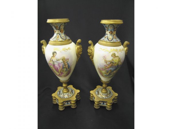 Sevres Porcelain & Champleve Bronze Urns, handpai: handpainted maiden & cupid on one side, landscapes on other, artist signed, gorgeous enameling, faces on bronze handles, footed, 12" tall.