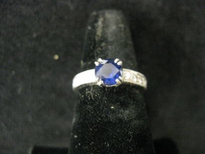 Sapphire & Diamond Ring, 1 carat round deep blue: 1 carat round deep blue gem with diamonds on each side totaling 1/4 carat in 18k white gold, with appraisal of $1800.00