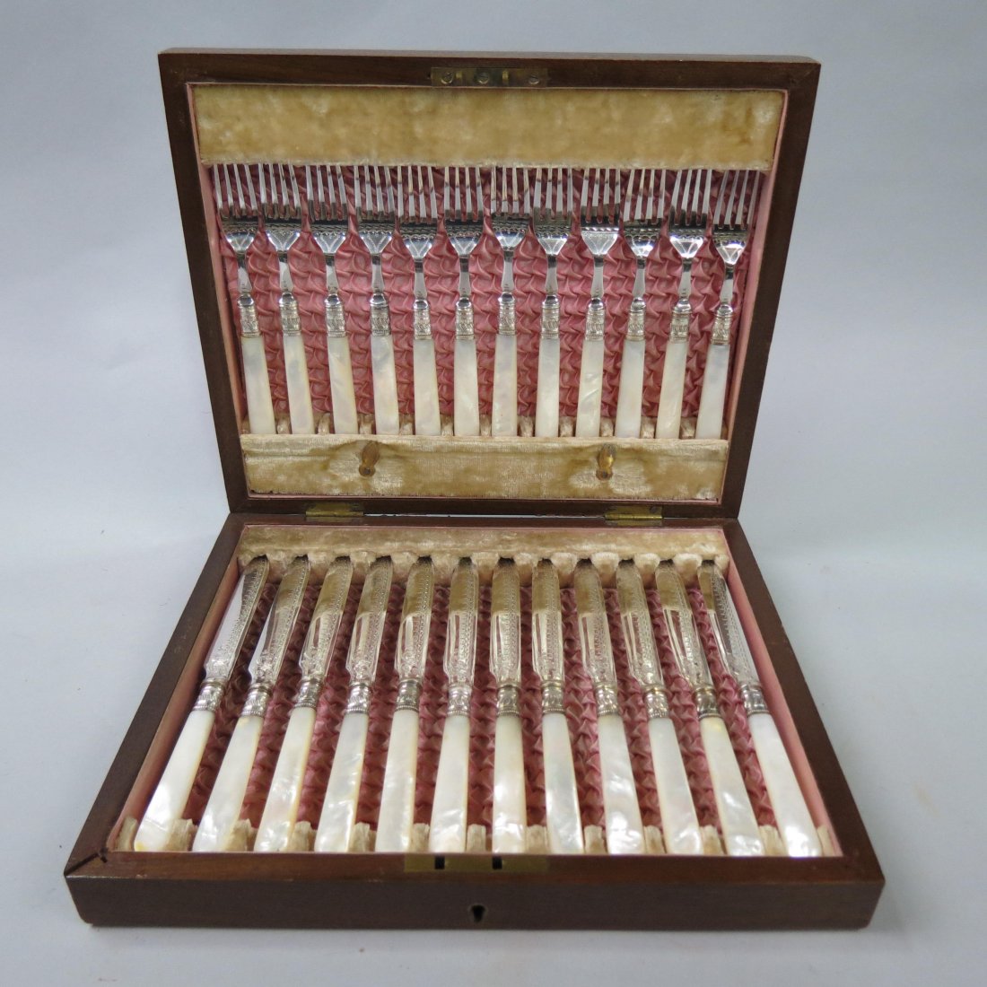 English Silver & M.O.P. Breakfast Service for 12,: forks and knives with elaborate engraving on blades, sterling silver ferrules, in original silk lined wooden box, excellent