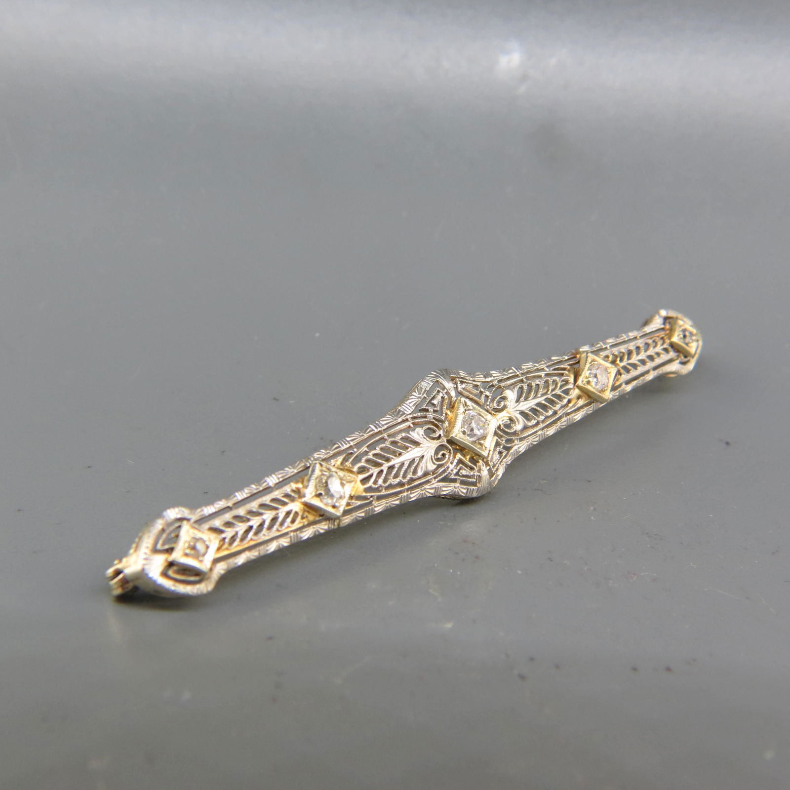 Diamond 14K Gold Filigree Bar Pin,: five round diamonds totaling .25 carat in 14K white gold, 2 7/8", 5 grams.