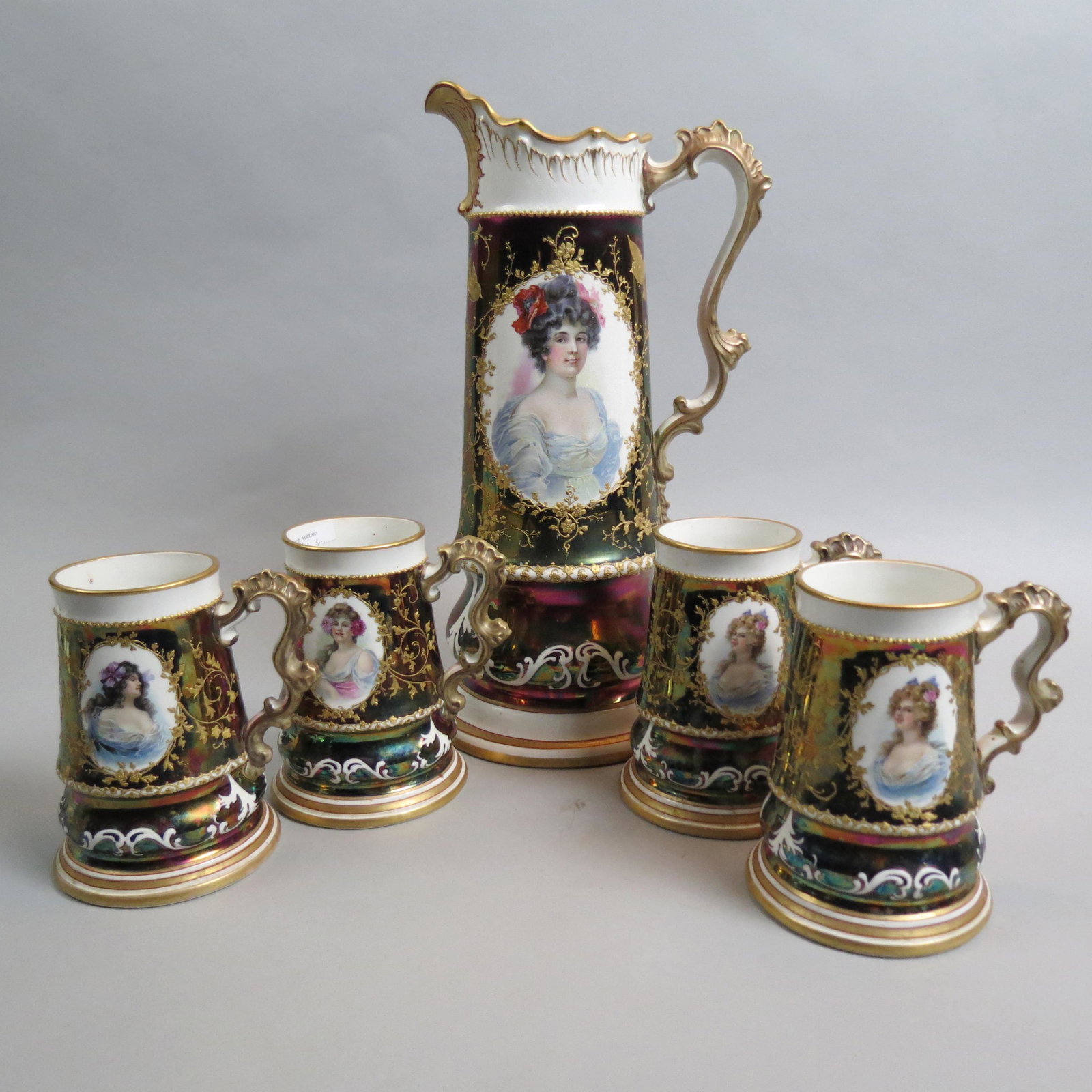 Knowles, Taylor & Knowles Porcelain Tankard & Mugs: rare portrait set "Beauties", portrait of women with iridescent "Tiffany" finish in manner of R.S. Prussia, elaborate gold work, 16" pitcher and 6 6 1/4" mugs, typical crazing otherwise excellent.....