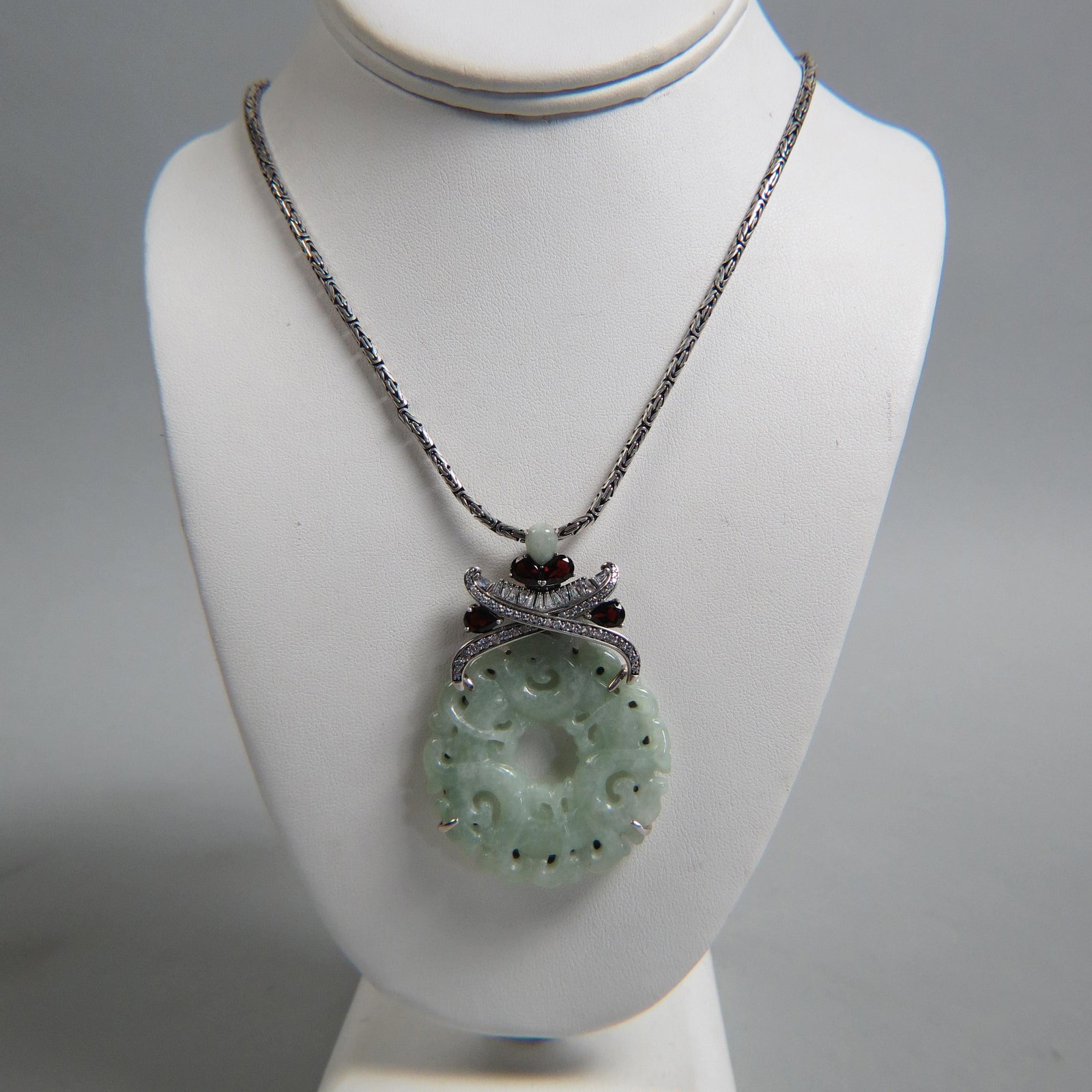 Chinese Carved Jade Sterling Necklace,: 2" disc with 4 pear shape garnets, baguette and round CZ's, 24" long, 54 grams.