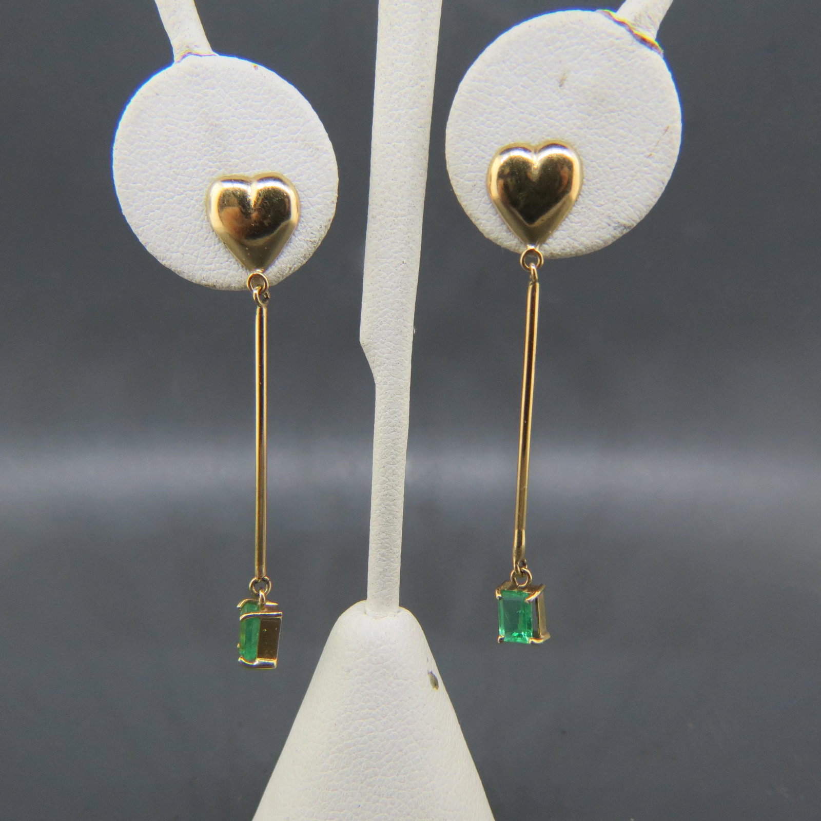 Emerald 14K Gold Earrings,: each with an emerald cut gem weighing over 1/2 carat, dangle style with heart top, pierced, 2" long.
