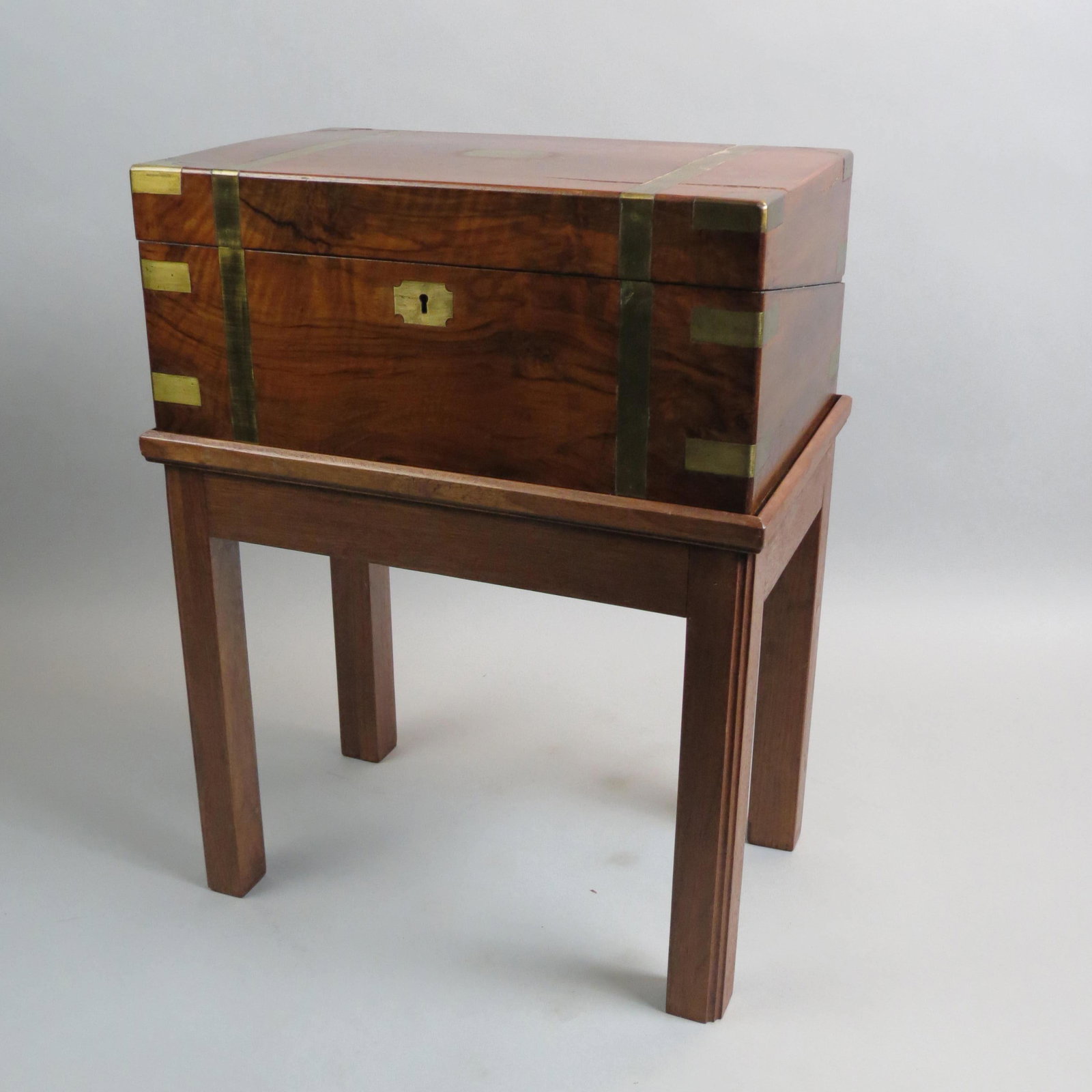 Antique Wooden Travel Lap Desk on Custom Stand,: campaign style brass straps and inlay, inner compartments and writing surfaces, with key, box is 10" x 15 1/2" x 7", stand is 14" tall.