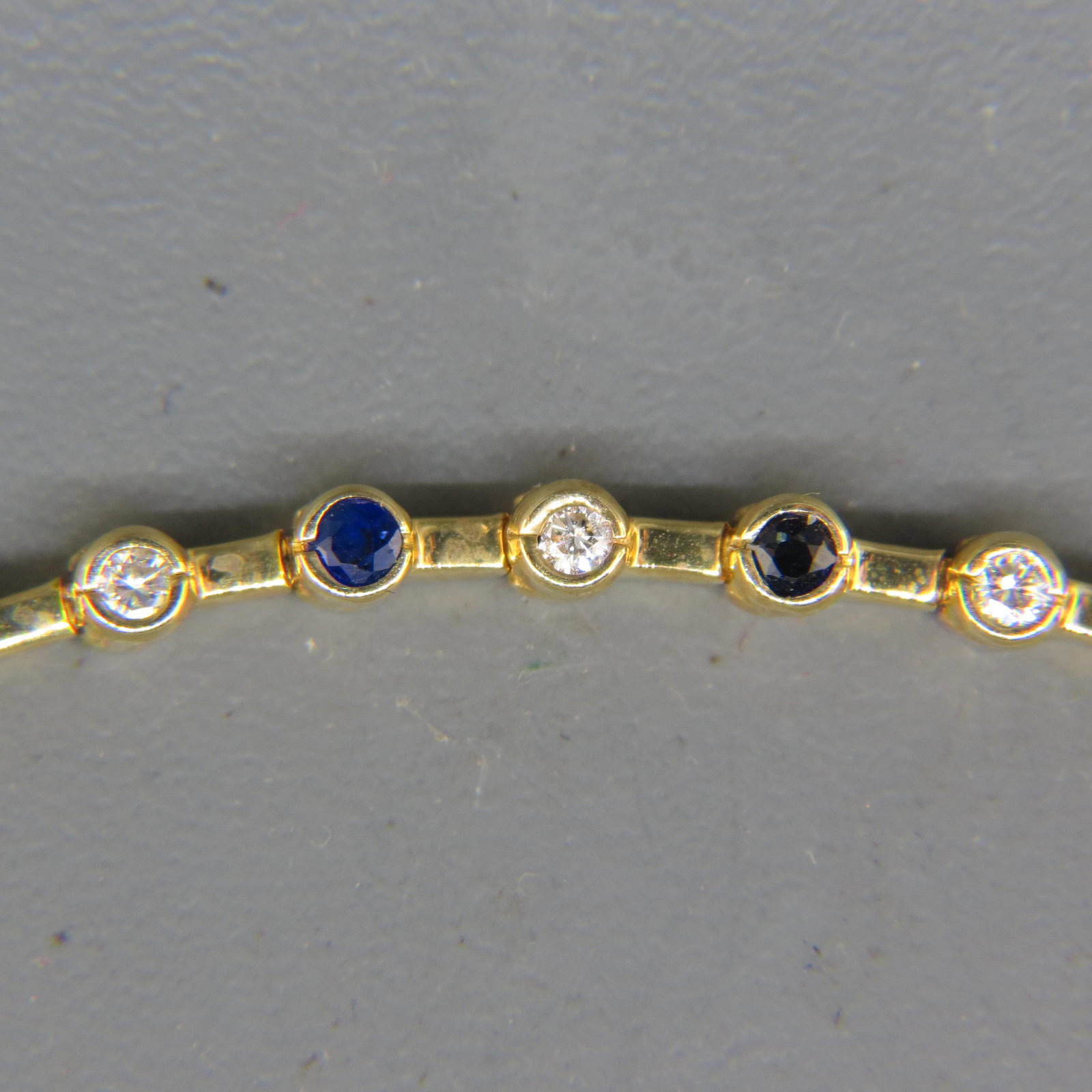 Diamond & Sapphire 14K Gold Bracelet,: alternating round gems, 14 diamonds and 15 deep blue sapphires, over 1 carat total, 14K yellow gold, 7" long, 11.1 grams.