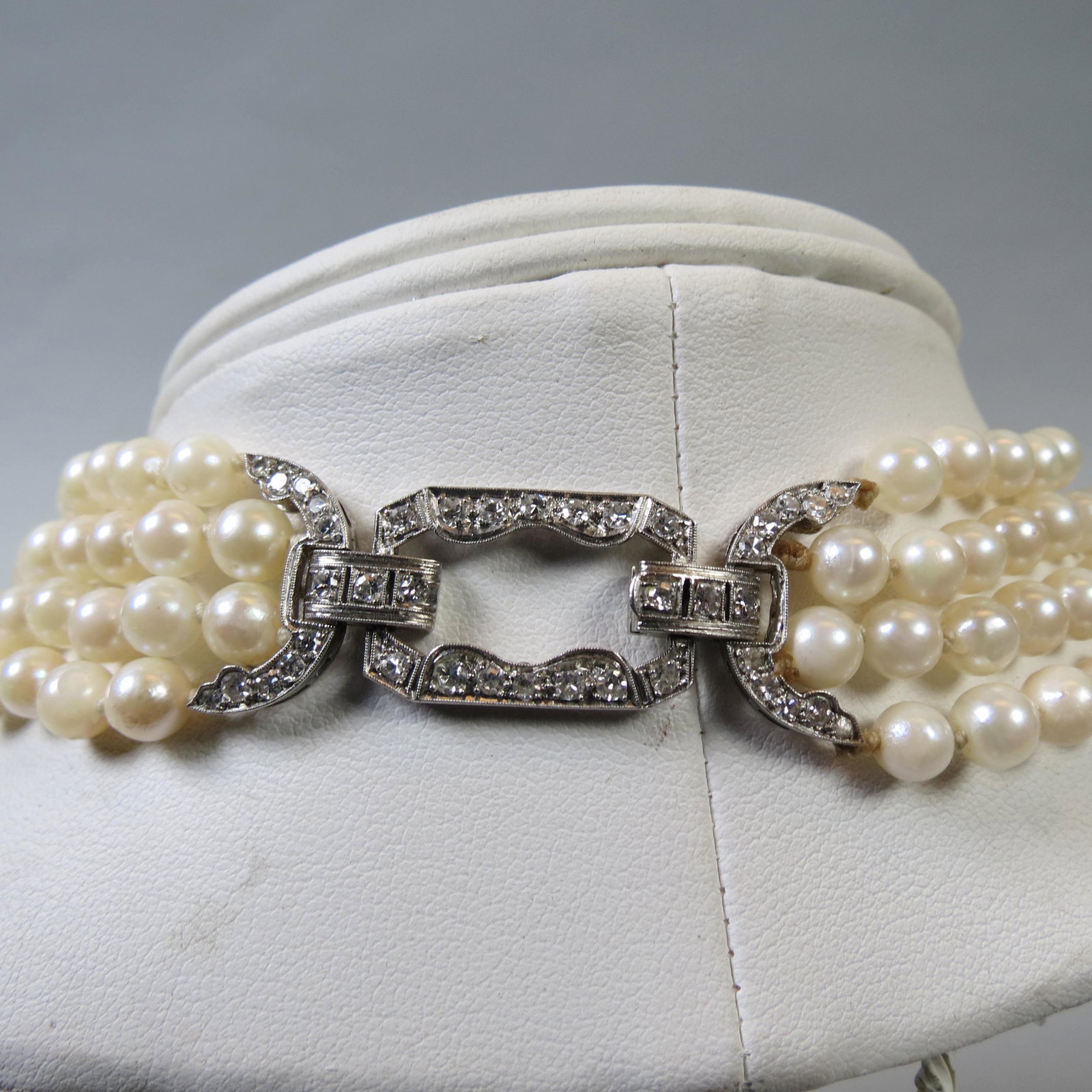 Platinum, Diamond & Pearl Necklace,: 4 strand, 37 round diamonds totaling 1 carat in antique clasp, pearls 5.75 o 6mm, with appraisal of $4,250.00, 20" long.