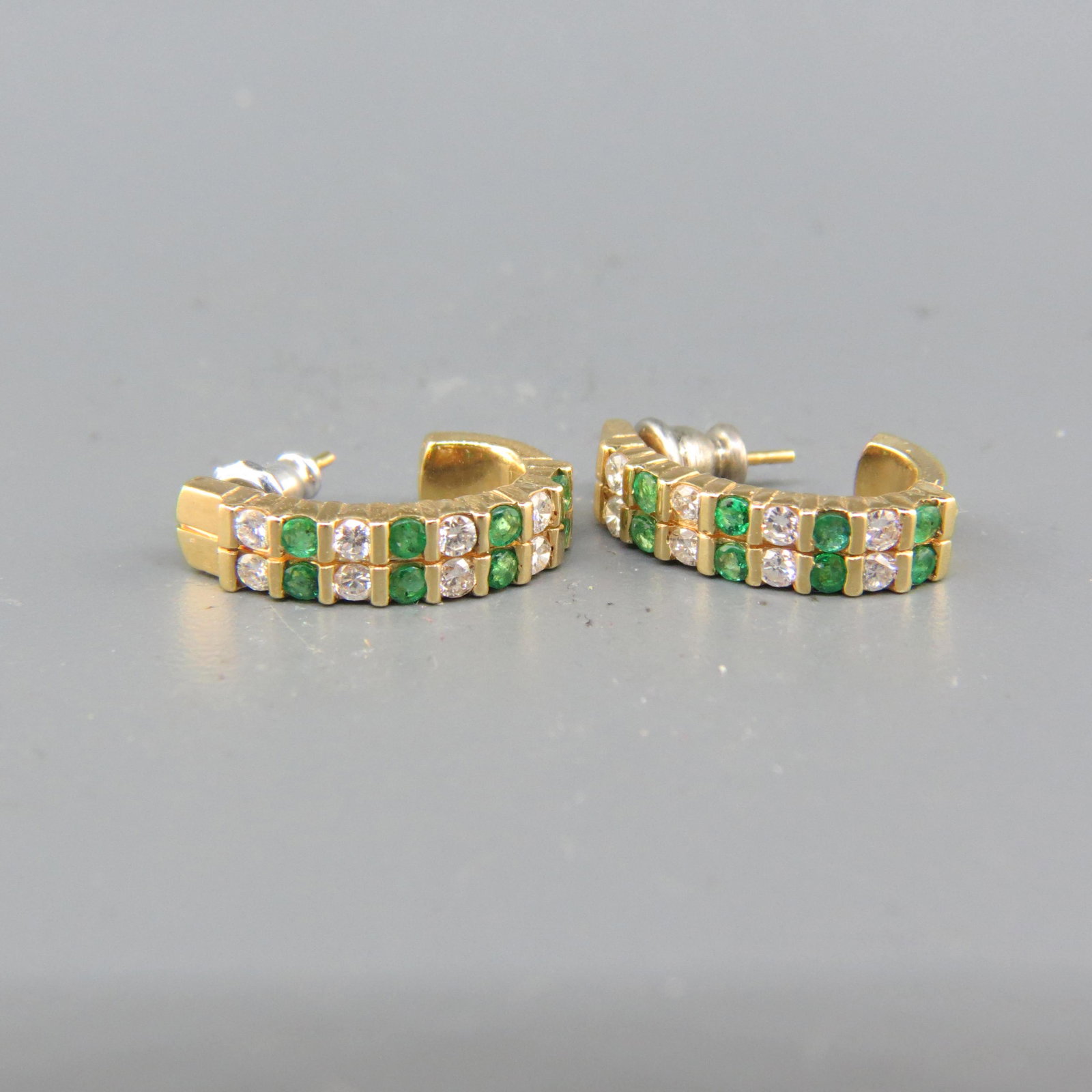 Emerald & Diamond Earrings,: 16 round emeralds totaling .40 carat and 16 round diamonds totaling .50 carat in 14K yellow gold pierced shrimp style setting, wih appraisal of $1,750.00, 7/8" long.