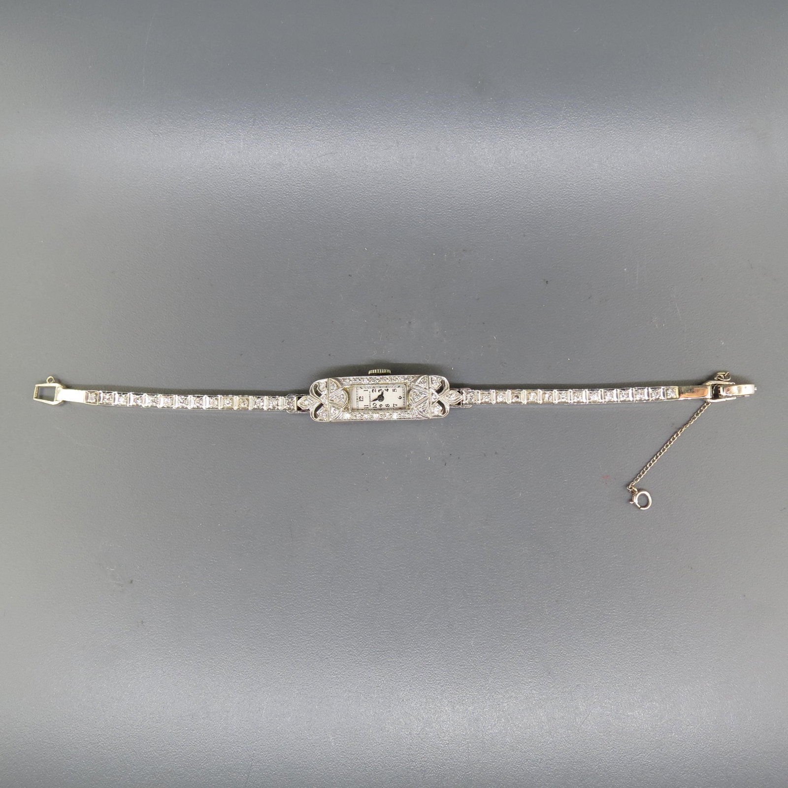 Diamond 14K Gold Ladies Wristwatch Art Deco,: by Monarch, 58 round diamonds totaling 1 carat, high grade, case & band 14K white gold, 6 1/4" long, 15.8 grams, with appraisal of $3,450.00.
