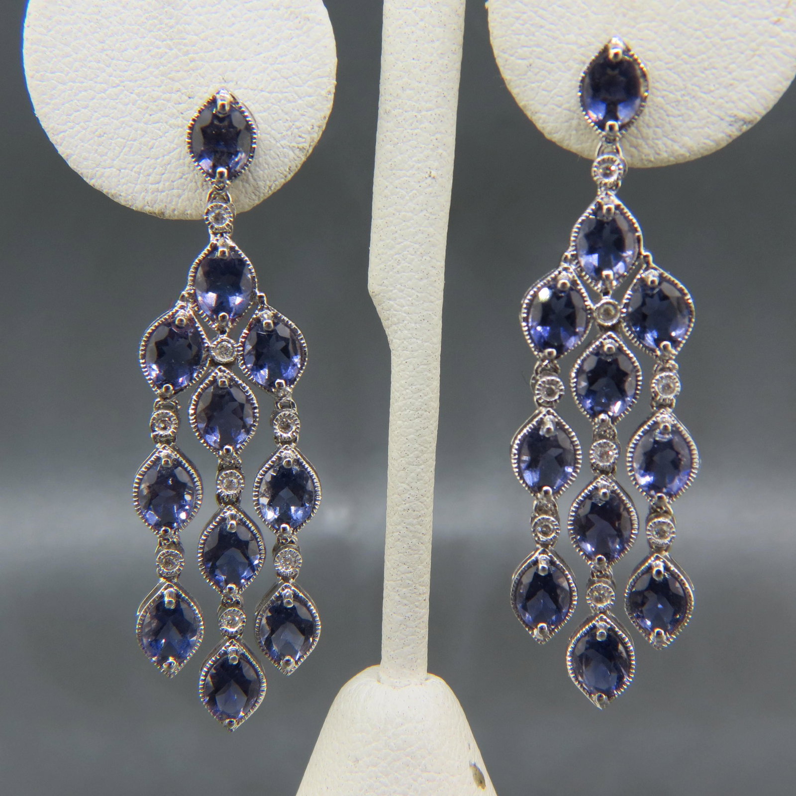 Tanzanite 18K Gold Earrings,: fancy dangling, chandelier style, pierced, 22 oval gems weighing 11 carats in 18K white gold, with appraisal of $3,850.00, 2" long.
