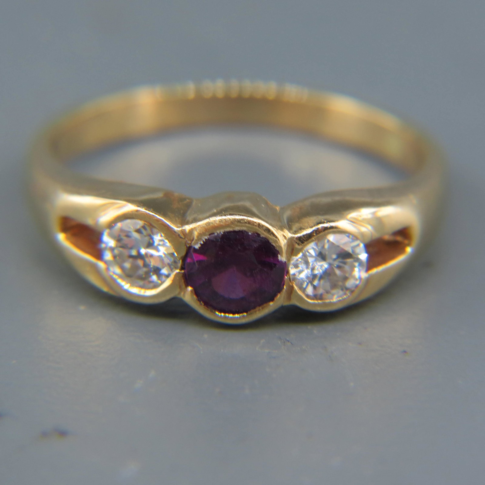 Diamond & Garnet Ring,: two round diamonds totaling .50 carat and deep red garnet weighing .50 carat in 14K yellow gold, with appraisal of $3,000.00, sold to benefit the Blue Ridge Humane Society.