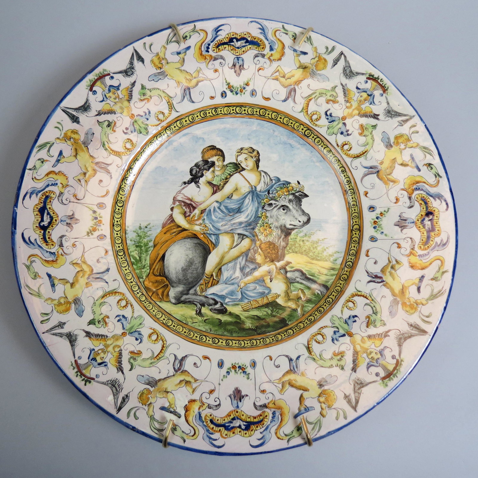 Italian Majolica Pottery Charger,: scene of maidens and cupid, Renaissance style, elaborate border with fish, birds, trees, cherubs and more, 18" diameter.