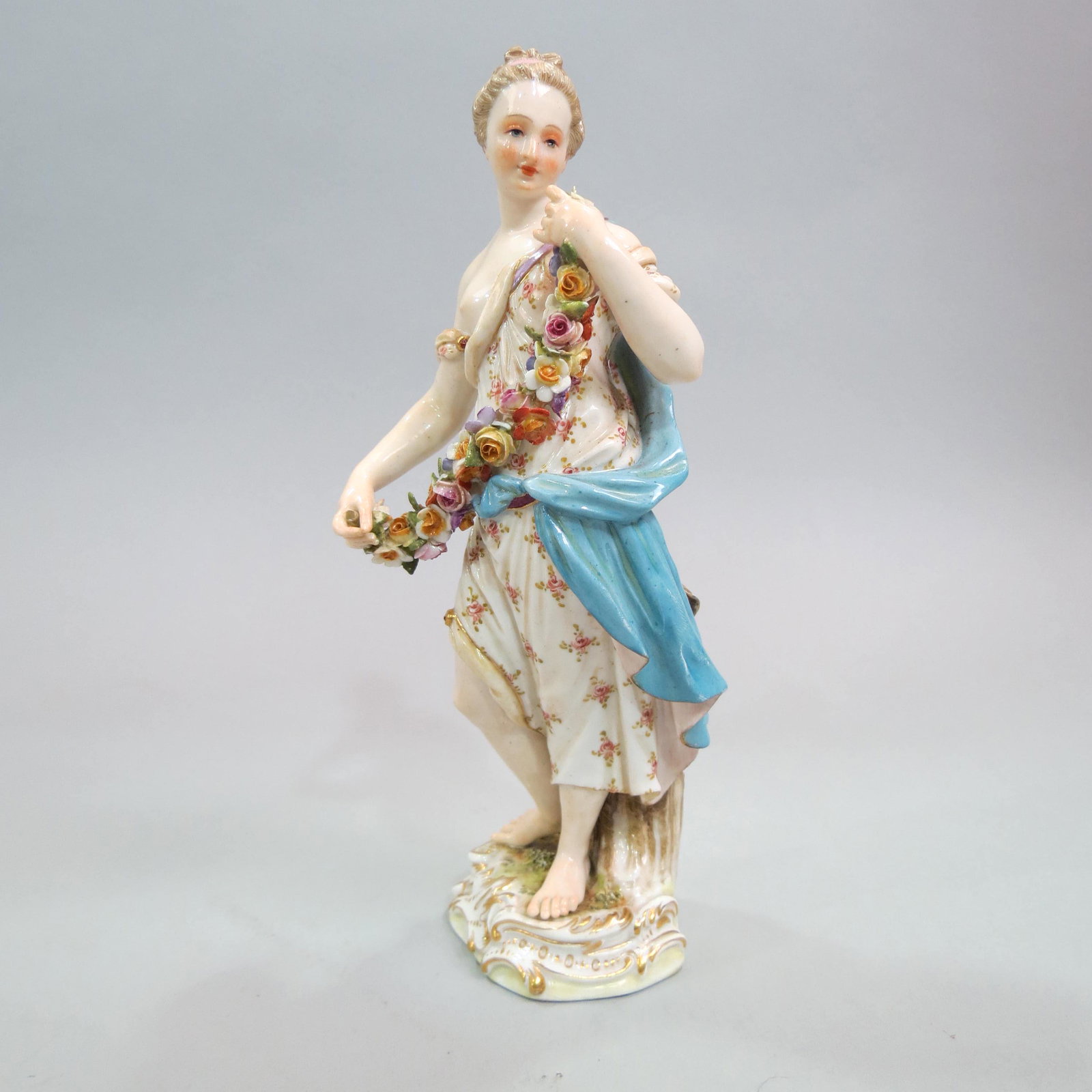 Meissen Porcelain Figurine of Lady & Flowers,: she is with a floral garland, 7 1/2", C-84, crossed swords mark.