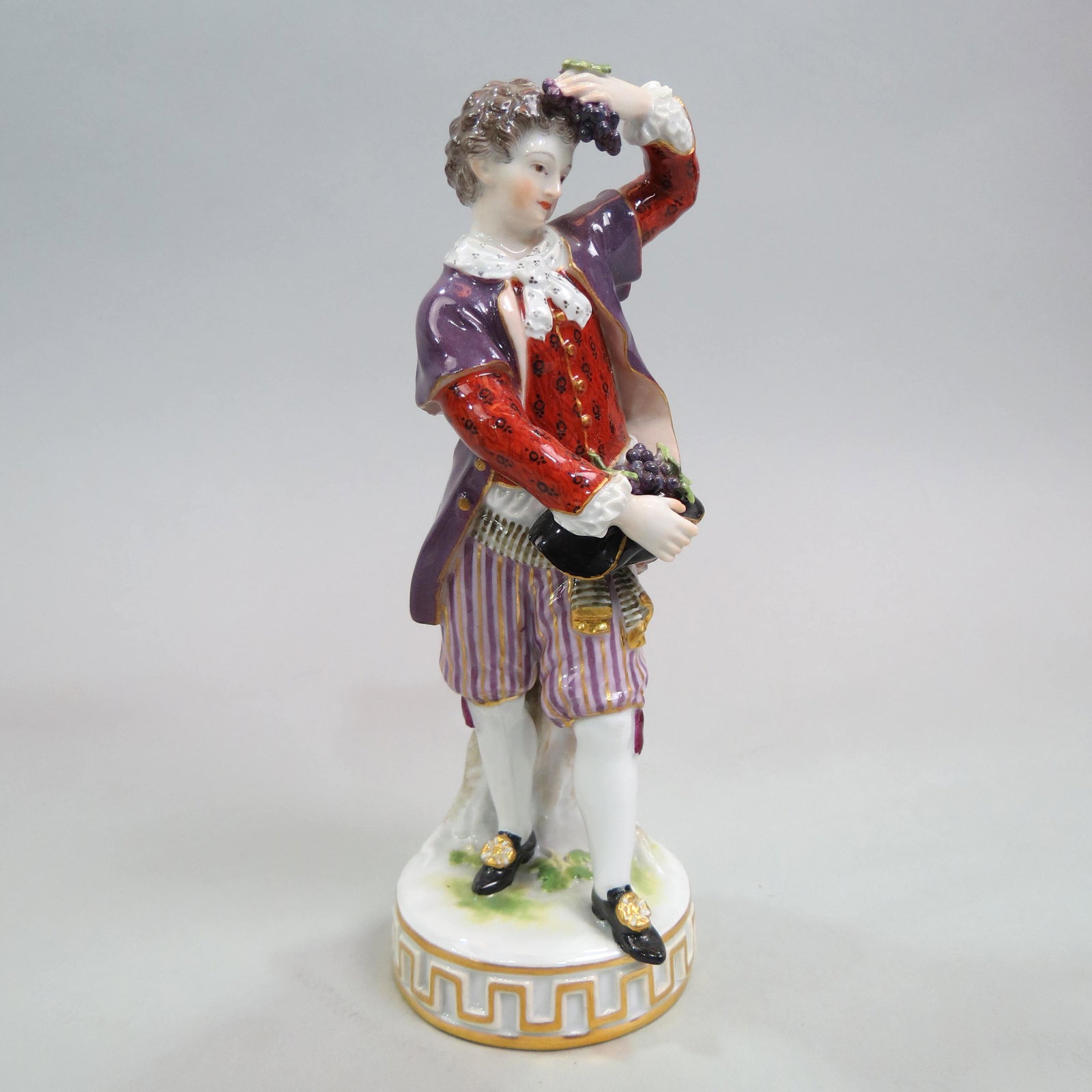 Meissen Porcelain Figurine of a Young Man,: with clusters of grapes, 6 1/2", F-84, crossed swords mark.