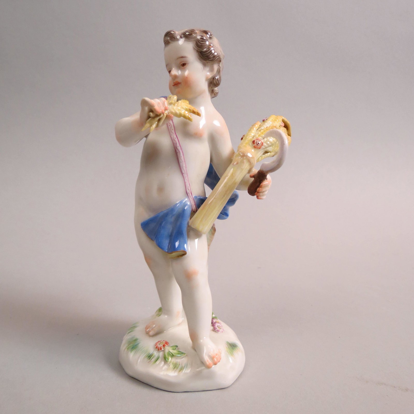Meissen Porcelain Figurine of Child Harvesting: Wheat, putti type, blue cloth on shoulder, 5 1/2", #1470, crossed swords mark, excellent.