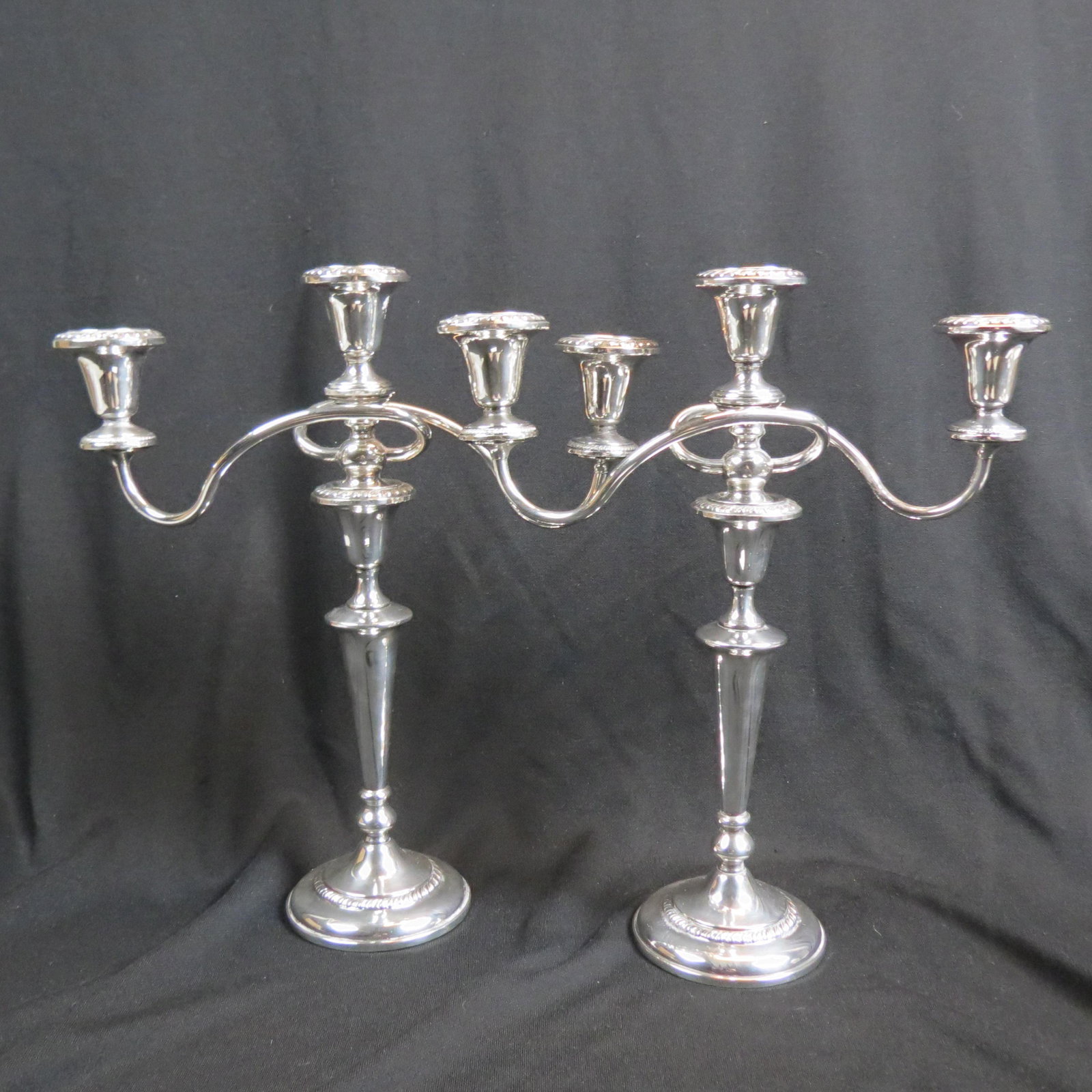 Pair of Sterling Silver Candelabra,: gadroon design by Revere Silversmiths, triple sconce convertible to singles, 15" tall, 13" across, weighted, 2870 grams total.