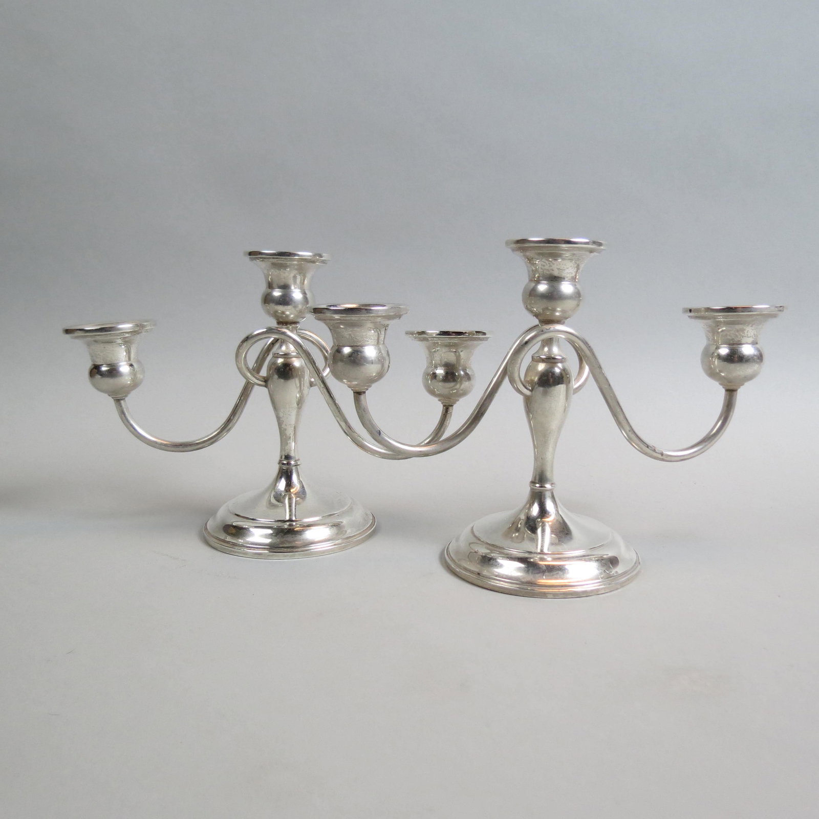 Pair of Sterling Silver Candelabra,: triple sconce, 6 1/2" tall, 9 1/2" wide, weighted, by Preisner, 1020 grams total.