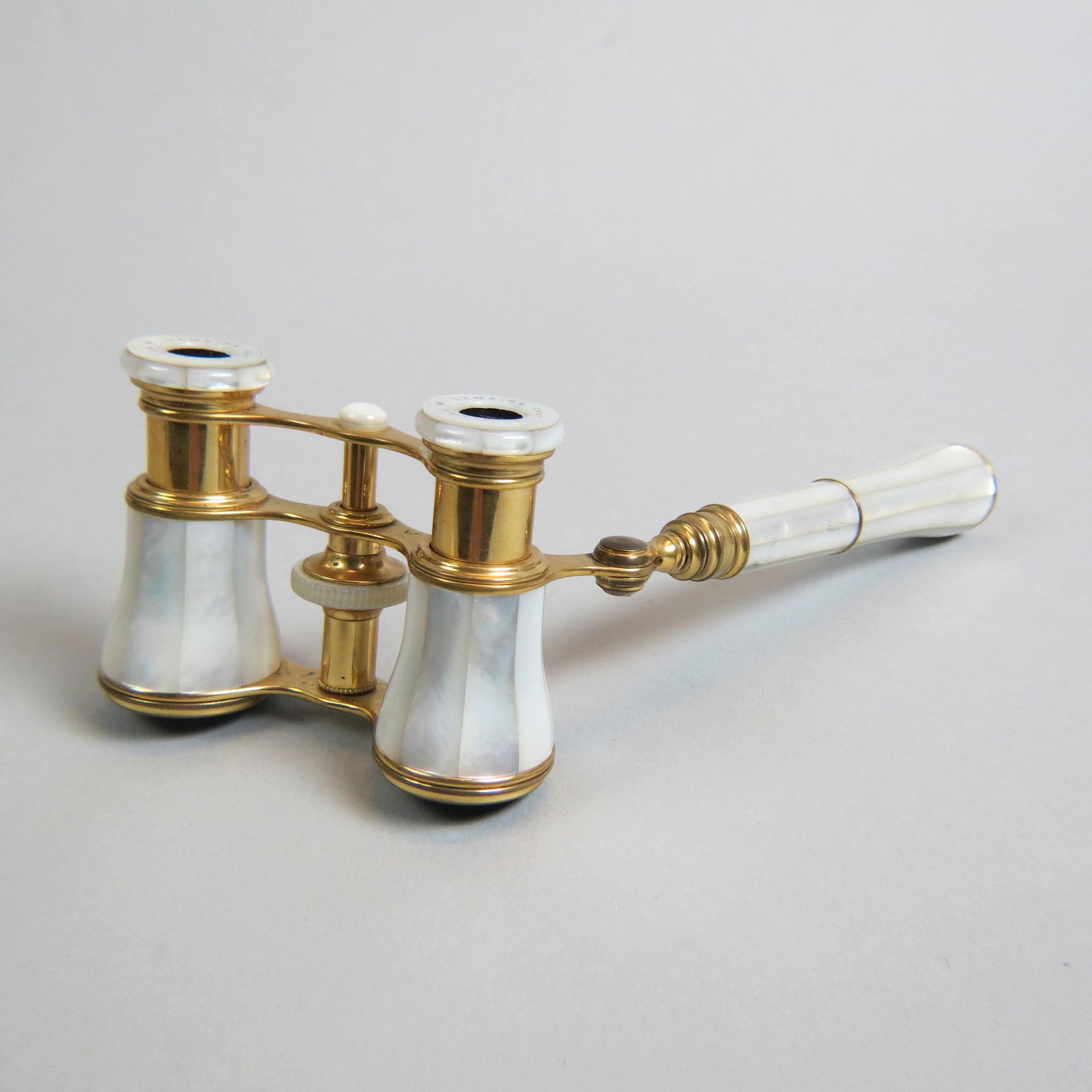 French Opera Glasses by Lemaire Paris,: with telescopic handle, mother-of-pearl and gilt design, excellent.