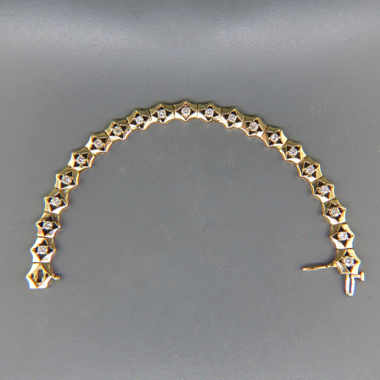 Diamond Bracelet,: 20 round diamonds totaling 2 carats in 14K yellow gold, with approval of $6,450.00, 7 1/4" long.