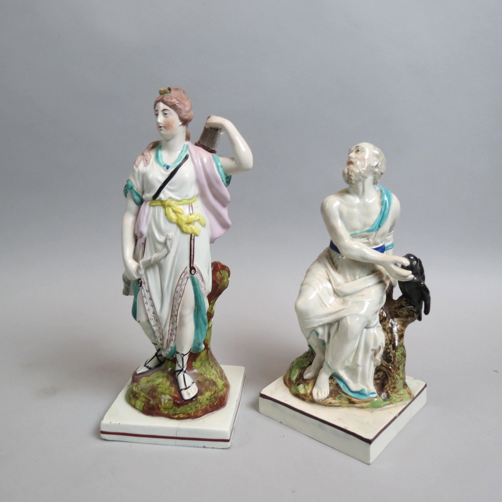 Pair Rare Saffordshire Soft Paste Figurines,: lady with bow and arrows, seated man feeding raven, late 18th century.