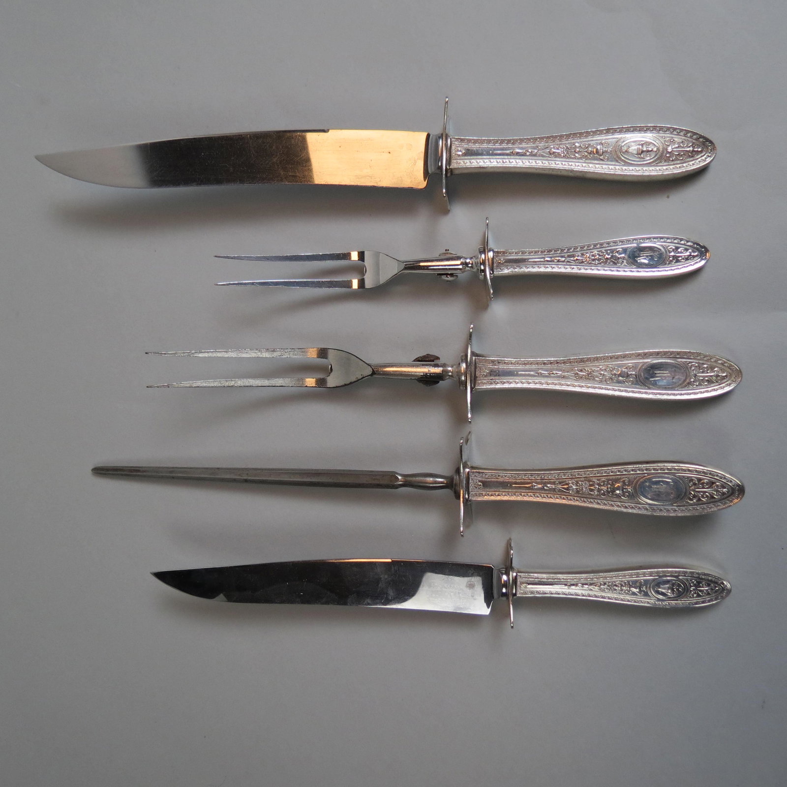 5 pc. International Sterling Wedgwood Carving Set: 1924, both roast and steak size knives and forks, plus the sharpener, 9" to 13", monogrammed.