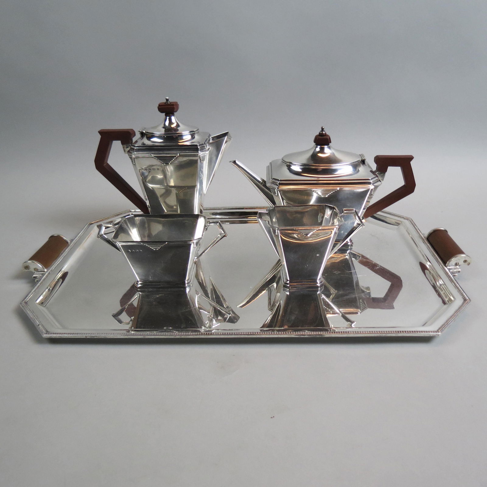 5 pc. English Sterling Tea & Coffee Service with Tray,: Art Deco style design, hallmarks of 1931 thru 1934, Birmingham, makers mark WN Ltd., tray is 14 3/8" x 21", plus handles, coffeepot (8 1/2"), teapot (7"), creamer and open sugar, no monogram, 4870 gra