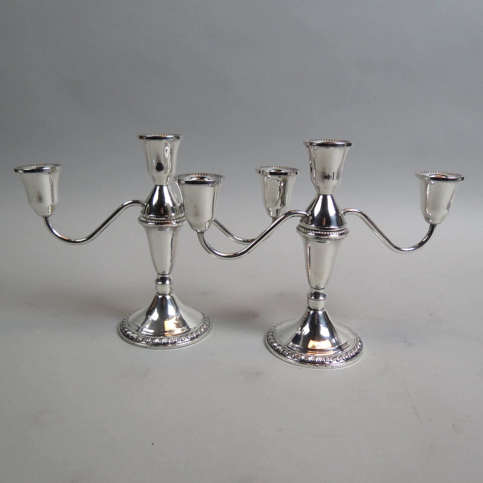 Pair Sterling Silver Candelabra by Duchin Studios,: three sconce convertible to single, 7 1/4" tall, 10" across, weighted, 916 grams total.