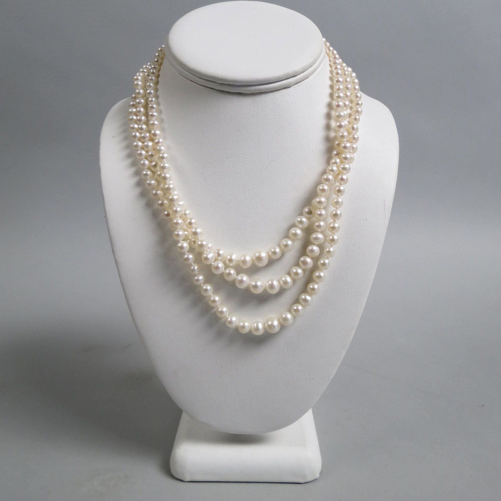 Pearl Necklace,: triple strand, 5 to 7.5mm, 16 1/2" long, plus tiered, 14K yellow gold clasp.