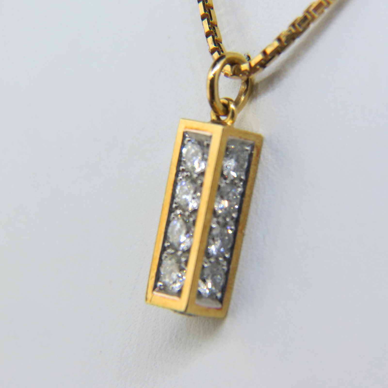 Diamond Pendant 18K Gold Cartier Type,: 17 round diamonds totaling 1.25 carat, high grade, in 1/2" long pendant on 18" chain, numbered #17260, found in estate in Cartier box, with appraisal of $3,950.00.
