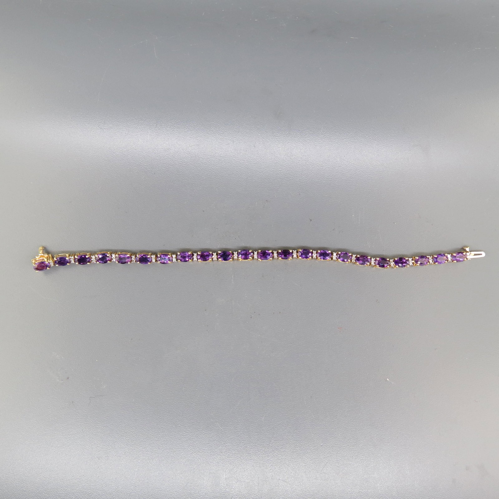 Amethyst & Diamond Bracelet,: 44 round diamonds totaling .50 carat and 22 over rich gems totaling 6.75 carat in 14K yellow gold, with appraisal of $2,450.00, 7" long.