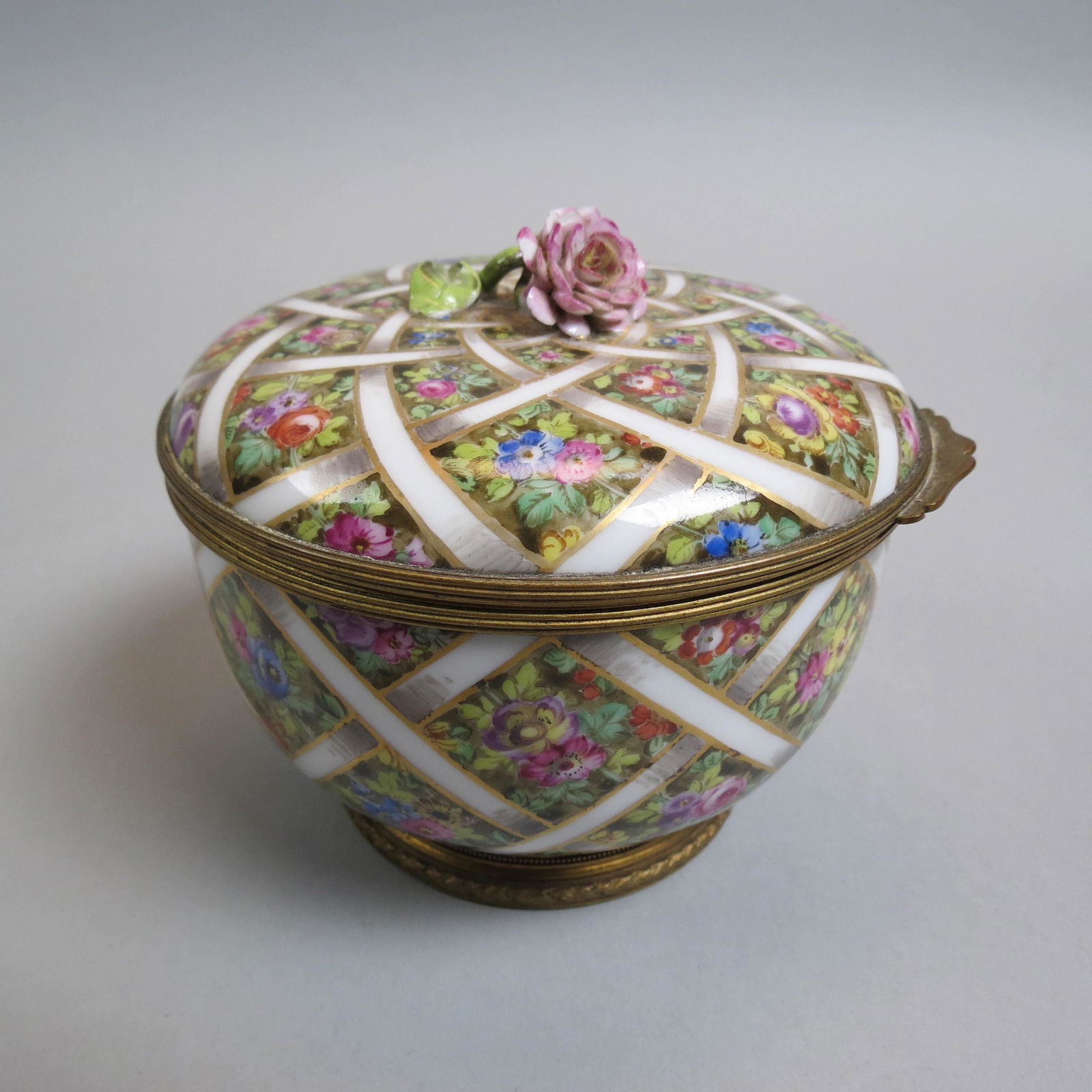 French Porcelain & Bronze Ormolu Box,: floral and ribbon design, 4 1/2" diameter, rose finial has minor petal loss.