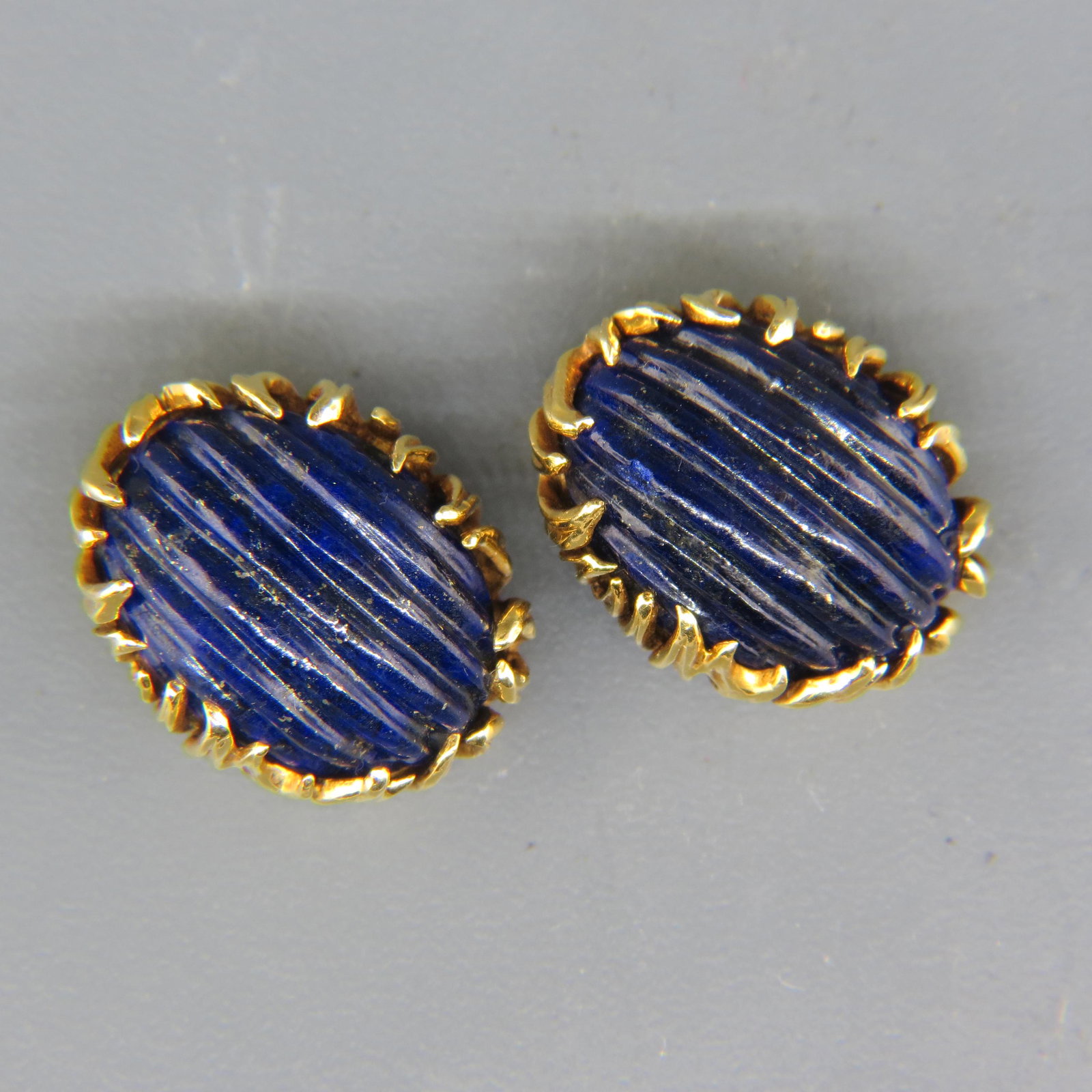 18K Gold Carved Lapis Lazuli Earrings Signed ED,: carved oval cabochons, 18K yellow gold clips, measuring approx. 5/8" x 1", 15.9 grams.