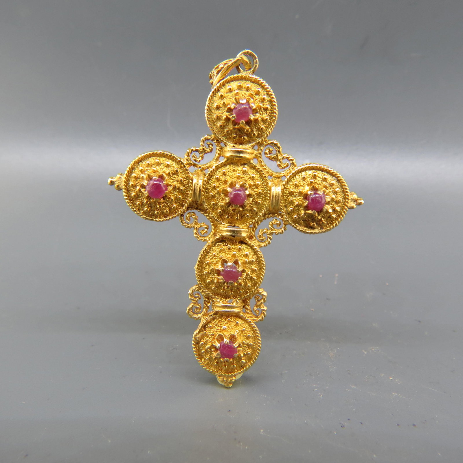 14K Gold Ruby Cross Pendant,: six cabochon gems in ornate setting, 11.4 grams, 2 1/2" long.