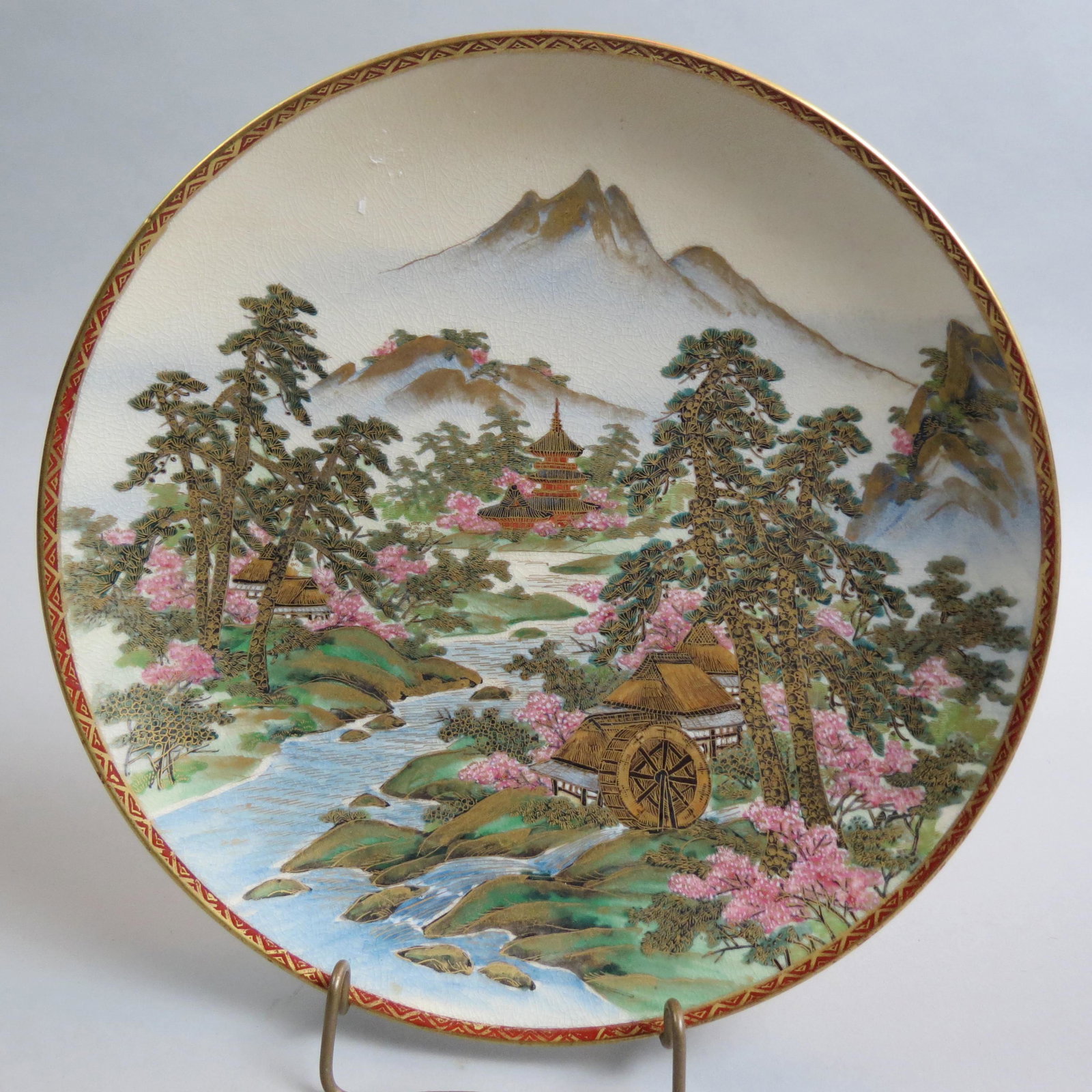 Japanese Satsuma Pottery Plate,: signed, finely detailed landscape with Mt. Fuji in background, homes, mill with water wheel and more, 10 1/4", excellent.