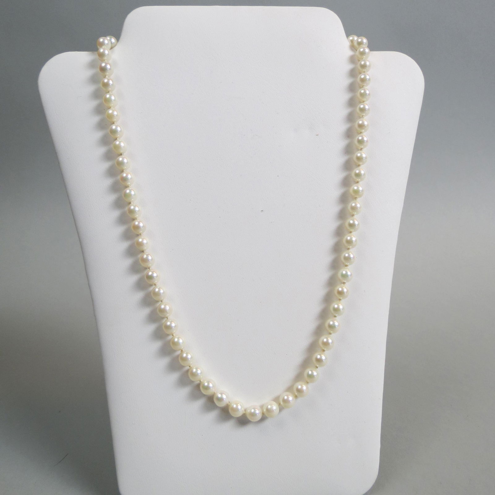 Pearl Necklace,: 65 lustrous salt water pearls measuring 6mm, 14K yellow gold clasp, 19" long.